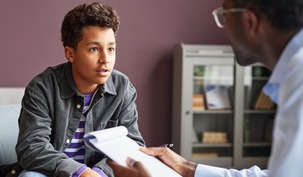 Excited Boy Talking to Psychologist