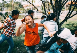 kids smiling and running around outside