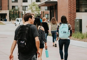 a-group-of-people-walking-on-a-sidewalk