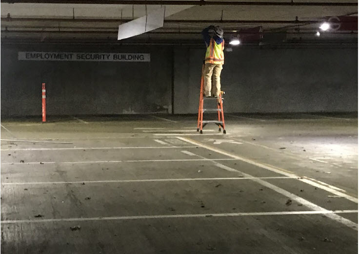 A contract worker hired by DES installs conduit in the Plaza Garage.