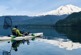 Kayak angler fishing for sockeye on Baker Lake with Mt. Baker in background