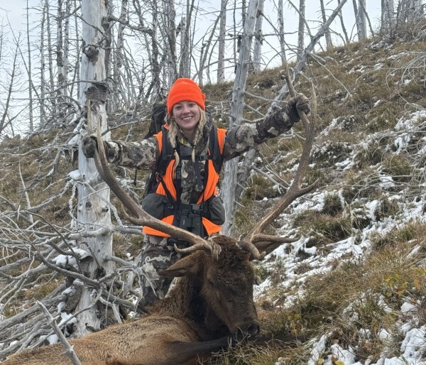 Teen behind her harvested elk