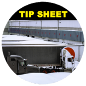 Image of loading terminal full of trailers and semi surrounded by feets of snow. 