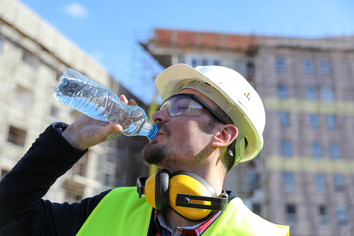 Construction worker drinking water