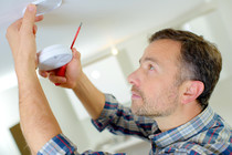 Man installing a smoke alarm