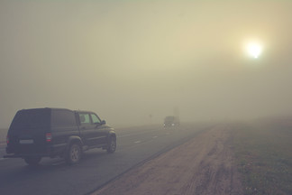 Truck on highway wildfire smoke