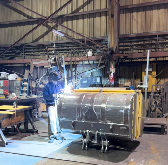 Workers pouring molten metal