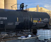 Worker on top of railcar