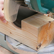 circular saw cutting block of wood