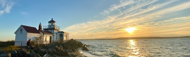 Lighthouse in Discovery Park against sunny sky