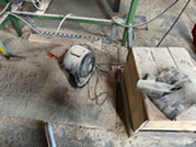 Space heater sitting on top of sawdust