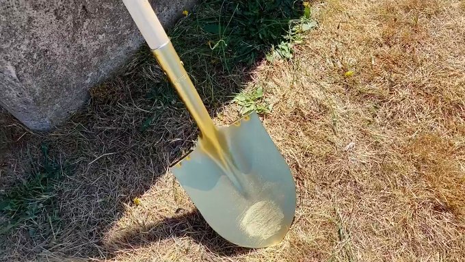 Screen capture of shovel breaking ground from a video at new housing project