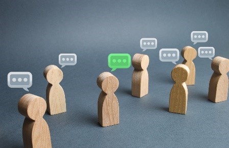 Image of wooden cutouts of people with word bubbles