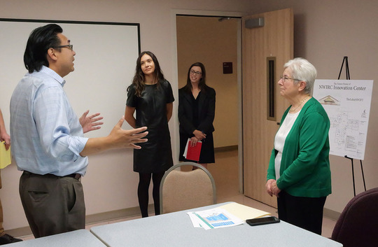 Director Mike Fong talks to representatives from the Northwest Innovation Resource Center (NWIRC).