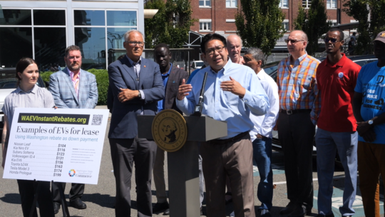 Commerce Director Mike Fong speaks during the EV Instant Rebate Program launch.