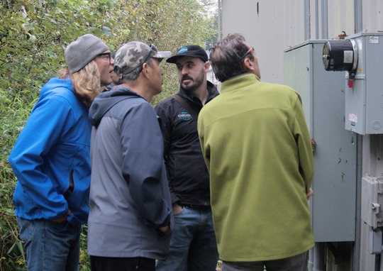 Cascadia Renewables with Point Roberts representatives examining electrical meters