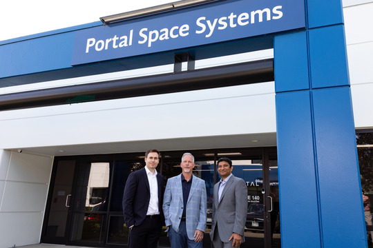 Three men stand at the Portal Space Systems headquarters.