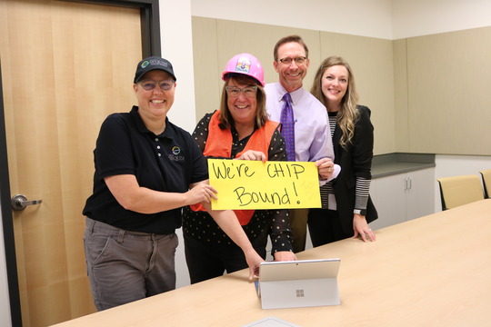 Three people celebrate Sequim's CHIP award.