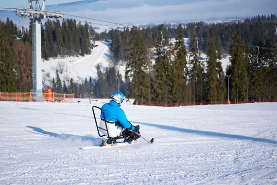 Skier using adaptive equipment
