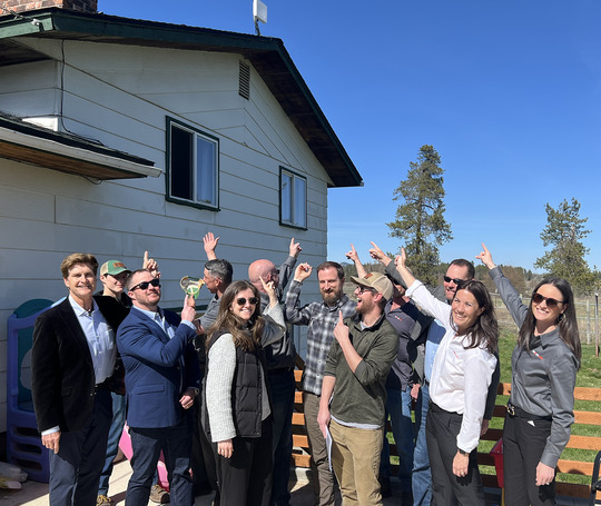 A group of people point to a wireless broadband receiver in Spokane.