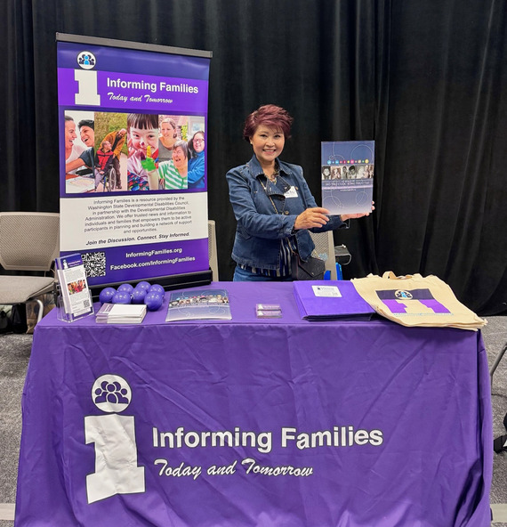 Informing Families Coordinator Levinh Tran shares Informing Families materials at an informational booth.