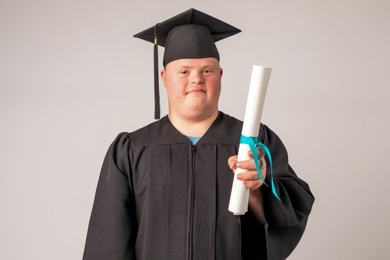 Proud graduate holding diploma
