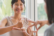 Two people communicating using sign language.