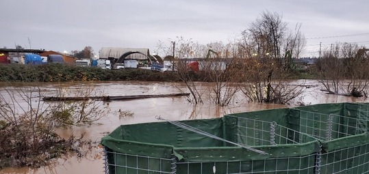 Installed flood barriers along a rapidly rising Green River 