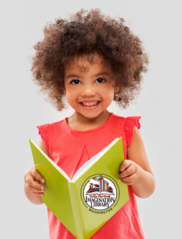 Child holding a book with the Washington Imagination Library logo on the cover