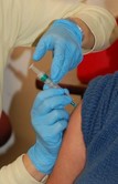 Person receiving a vaccination in their arm