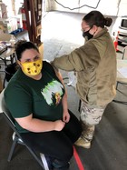 Woman receiving COVID-19 vaccine shot at Clark County mass vaccination site