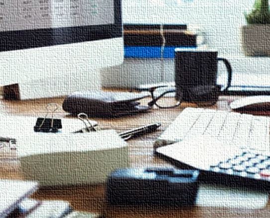 desk with computer and items indicating project activity