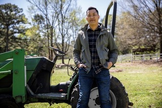 Man standing in front of a tractor