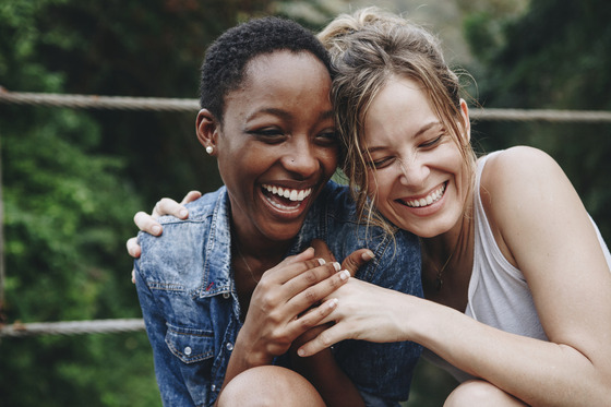 An image of two people hugging and smiling 