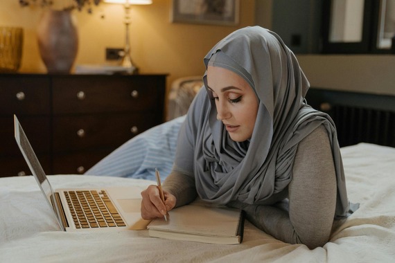 Woman in Gray Hijab Using Computer 