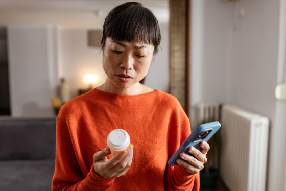 Person looking at pill bottle