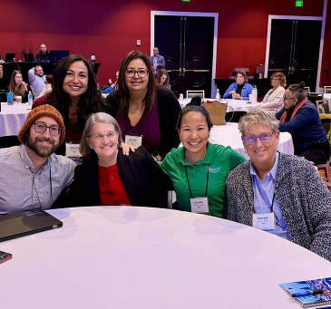 Group photo of the Board of Physical Therapy members and staff standing together and smiling in a professional setting.