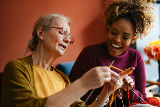 Older and younger adult knitting