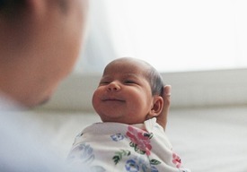 Smiling baby bundled in a blanket