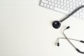 Desk with stethoscope and computer keyboard