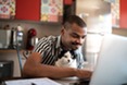 Young man working with cat