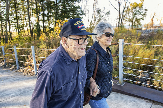 Two older adults walking in park