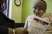 Image of a woman reading a flyer.