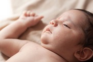 Close-up portrait of a newborn baby lying down