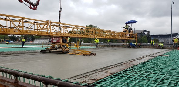 Crews smoothing concrete over steel rebar on the new SR 520 eastbound lanes.