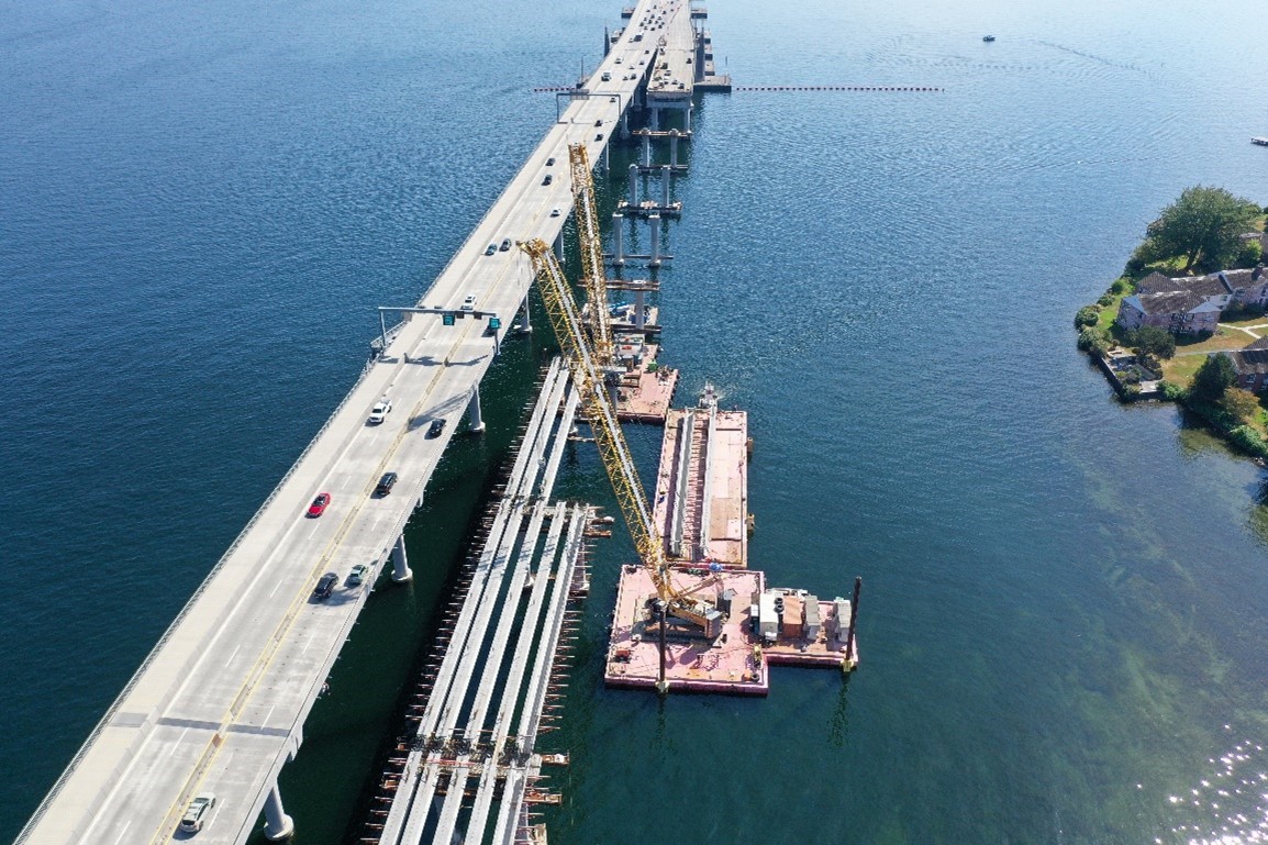 Photo looking east at construction of the future eastbound SR 520 bridge with Union Bay in the background