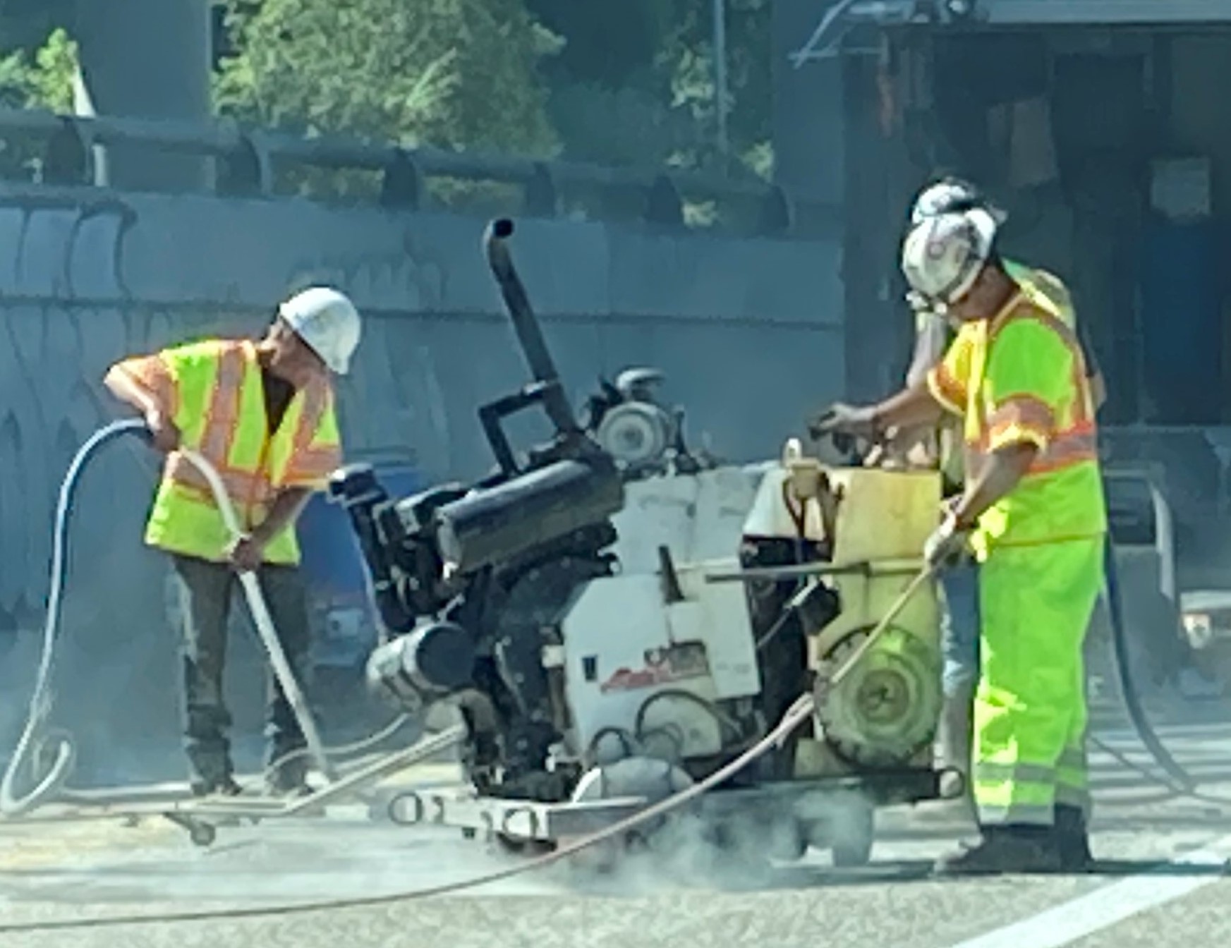A picture of crews saw-cutting concrete on I-5 in Seattle.