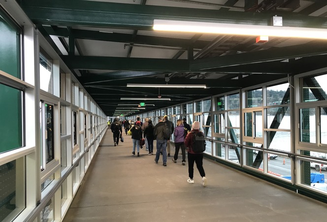 Passengers walk from the ferry towards the Bainbridge Terminal on the Overhead Loading Walkway