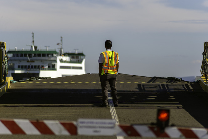 WSF Terminal employee waits for ferry coming into the landing area