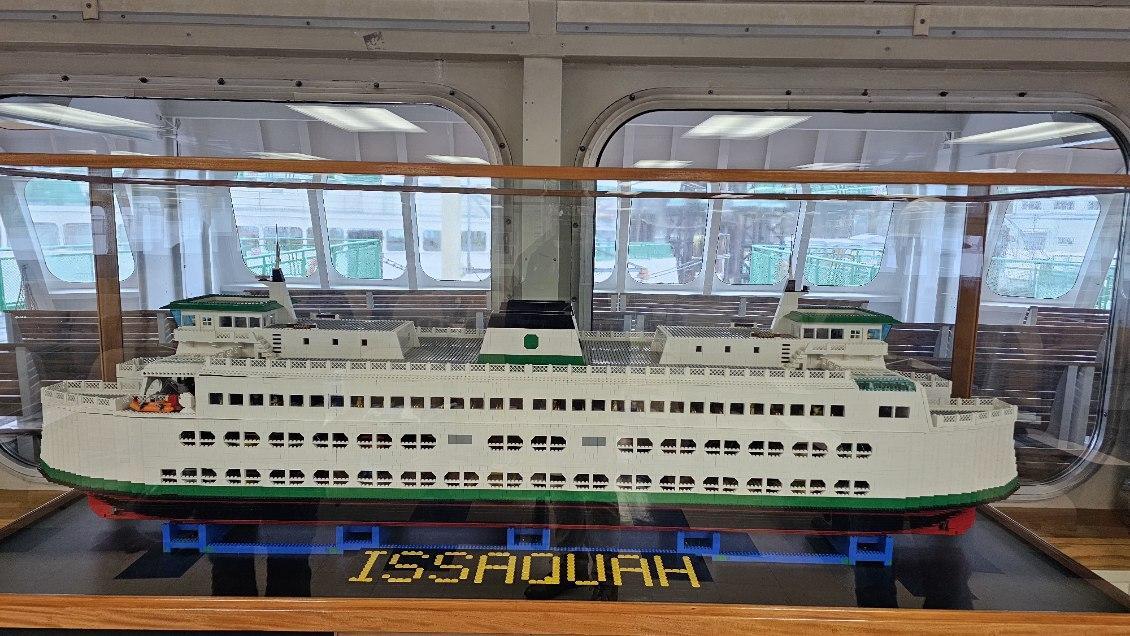 Lego model of a ferry named "Issaquah" in a glass case
